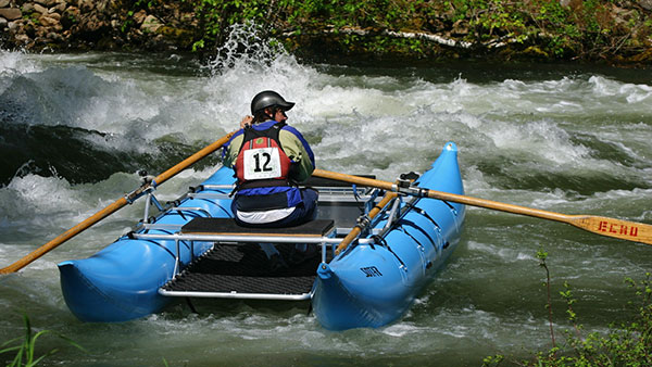 Zach on a cataraft on Fish Creek